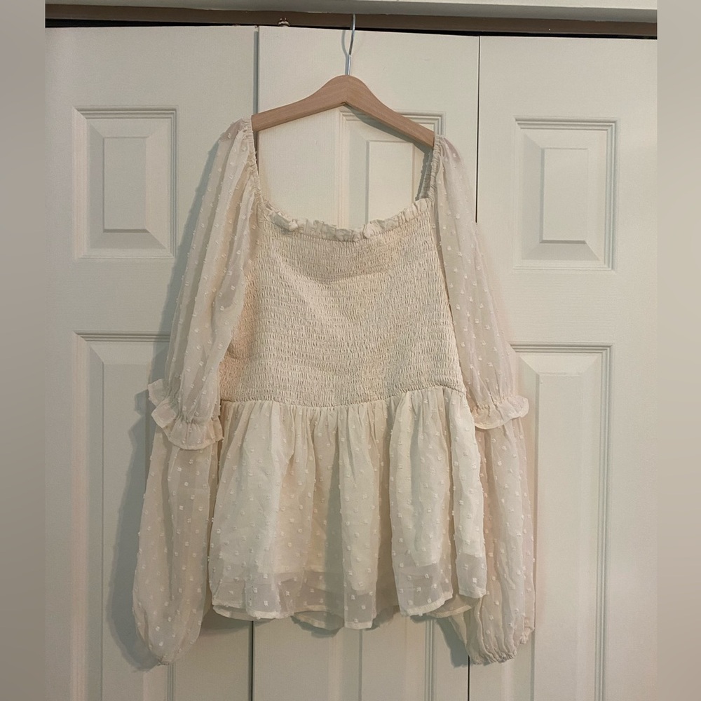 A white Hailey & CO. long sleeve blouse.